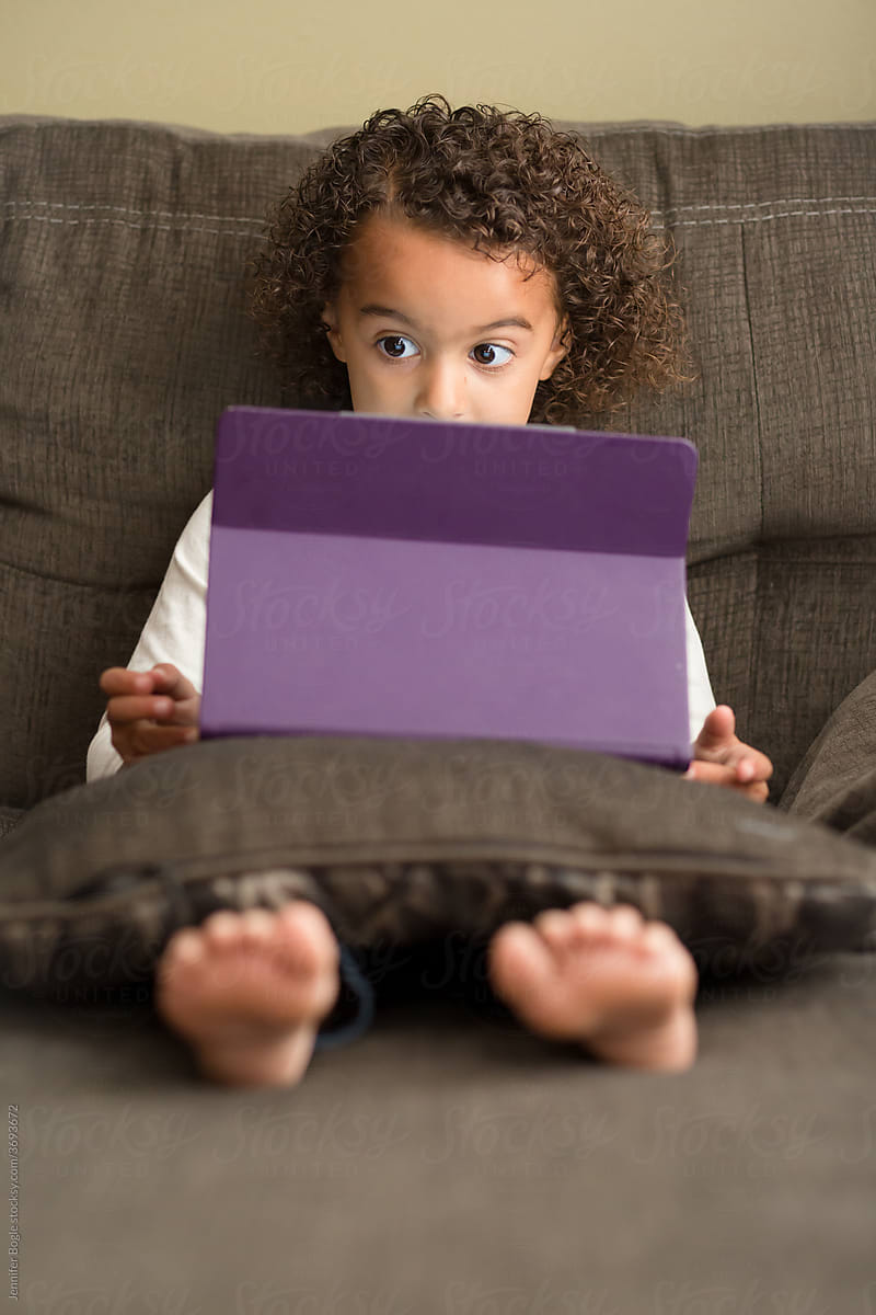Girl raises eyebrows as she reads tablet screen