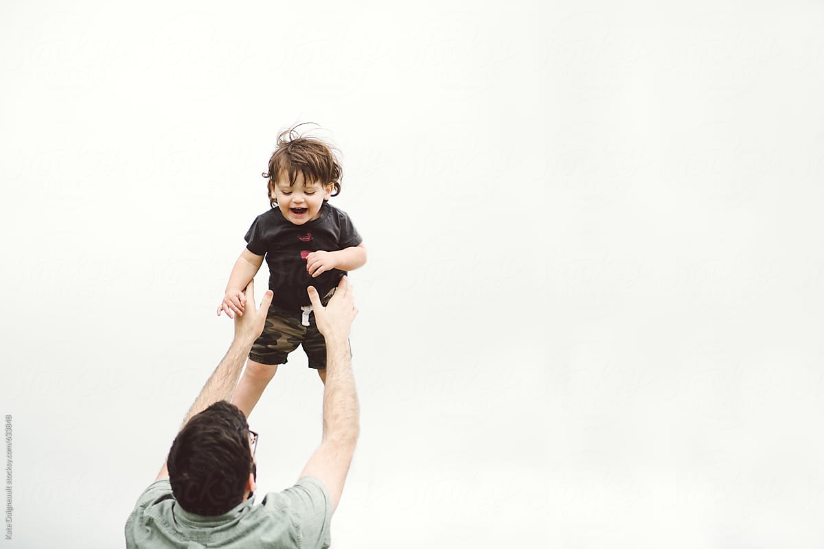 Father Throwing Son In The Air Outside By Stocksy Contributor Kate Ames Stocksy