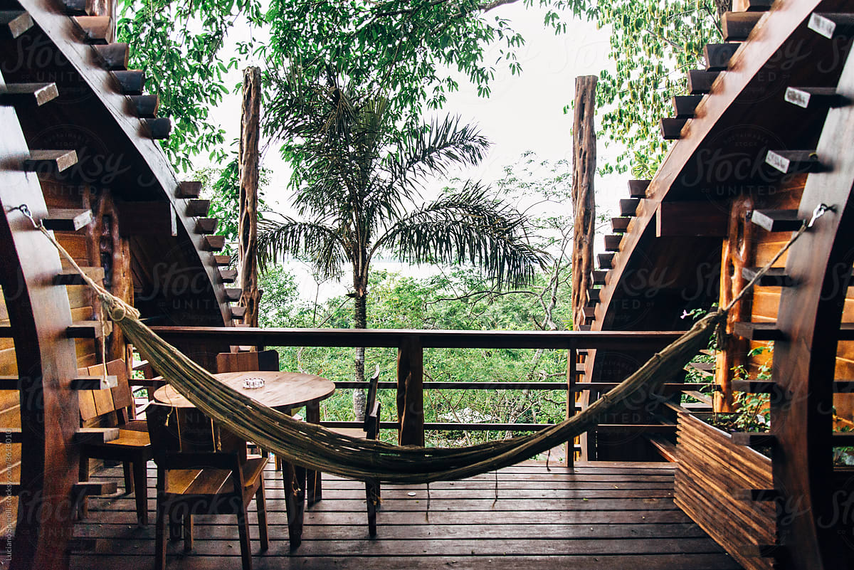 Hammock in the hotel balcony with table chair, view to amazon forest