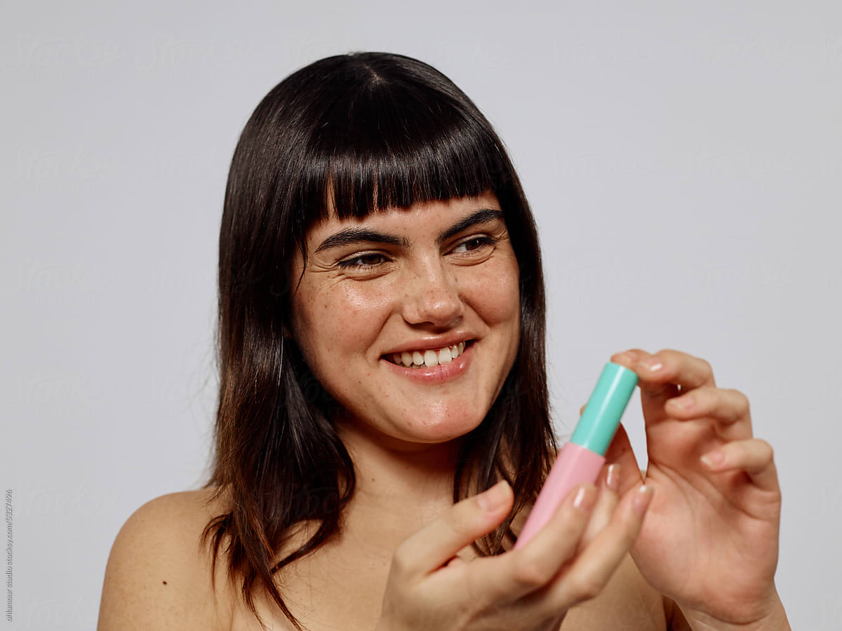 Playful woman with make up product
