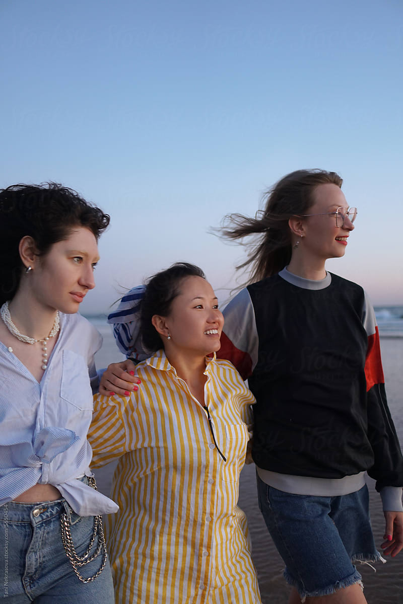 Three young females traveling together by the ocean. Friendship
