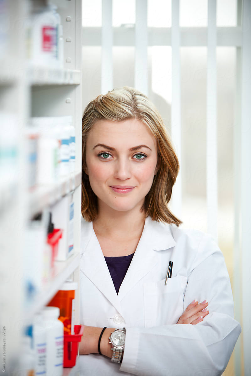 Pharmacy: Pharmacist Standing By Shelves