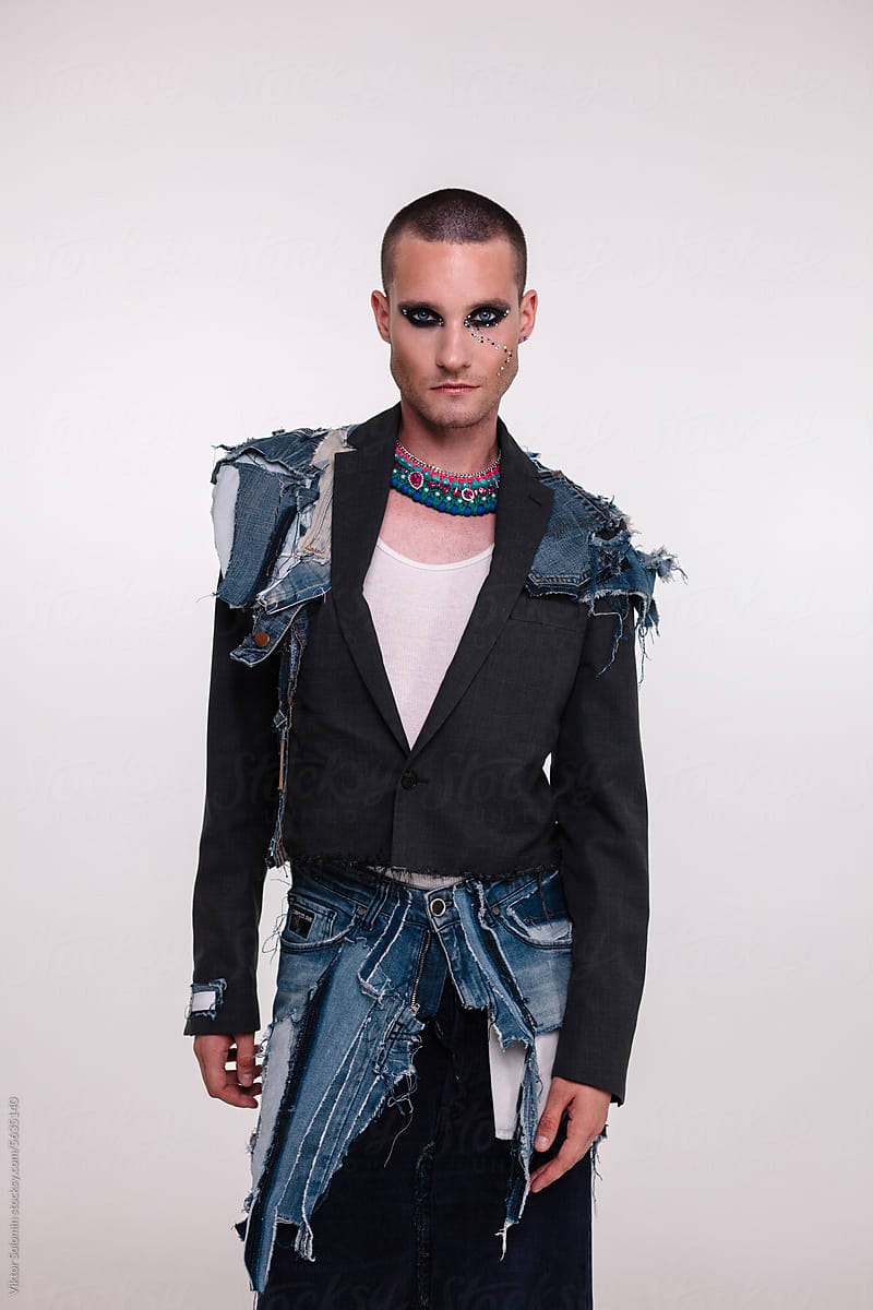 Stylish androgynous man. Handmade upcycle denim outfit in studio