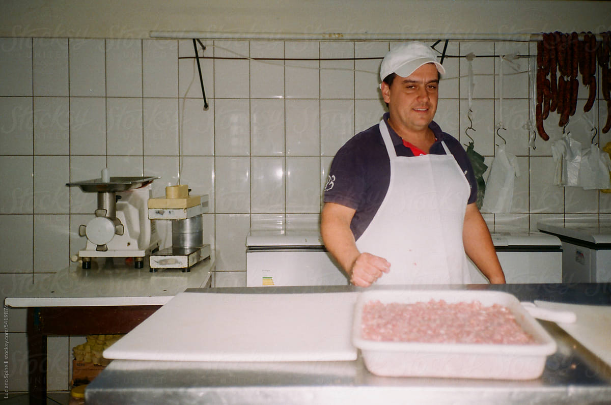 Artisan butcher processing meat to make sausage: manual production