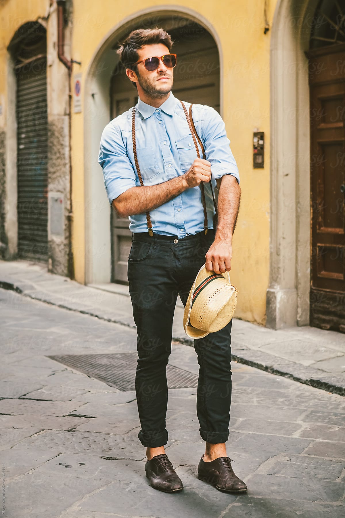 Handsome Man with a Vintage Denim Shirt Exploring an Old Italian Town
