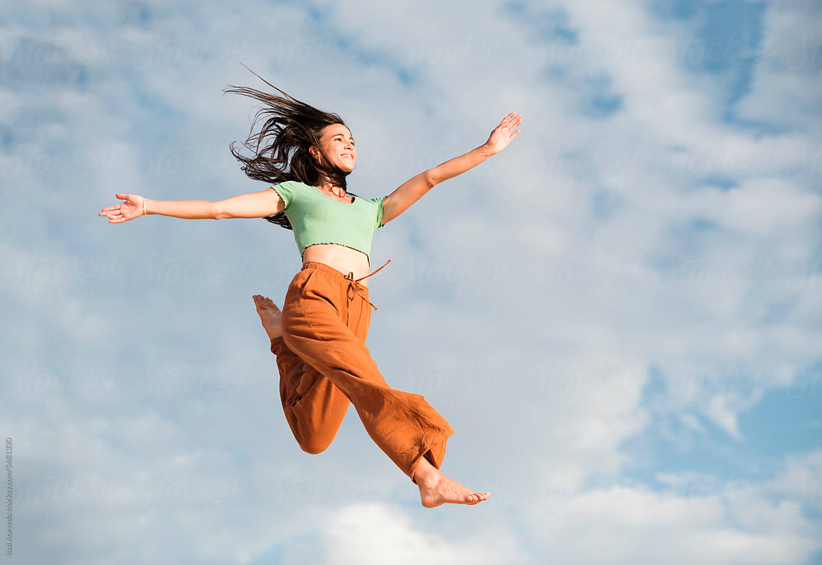 Cheerful woman jumping in the air