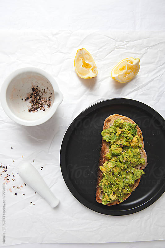 Making smashed avocado on toast with feta for breakfast