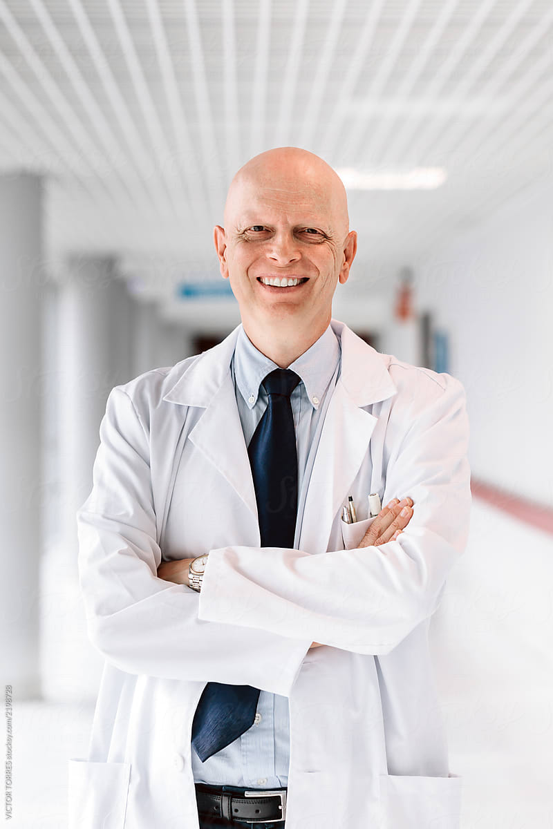 Portrait of happy confident doctor in the hospital corridor