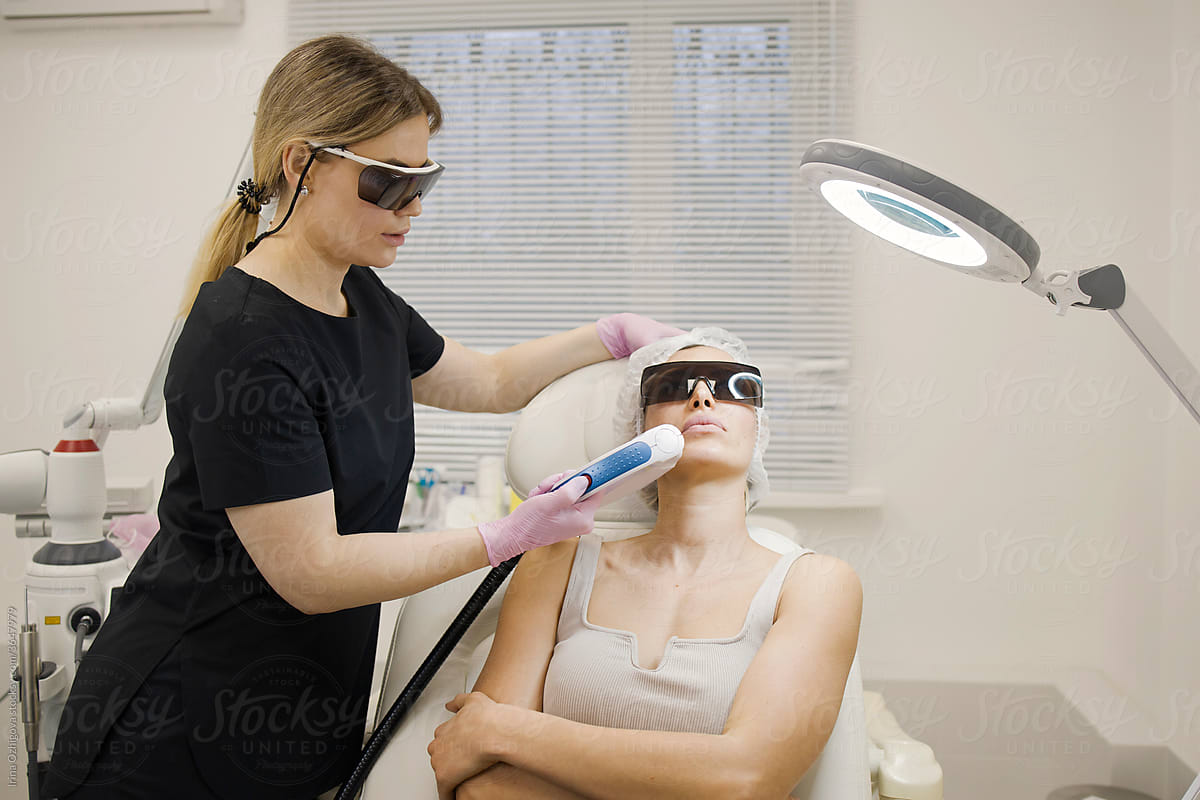 Young woman getting photorejuvenation procedure on a face