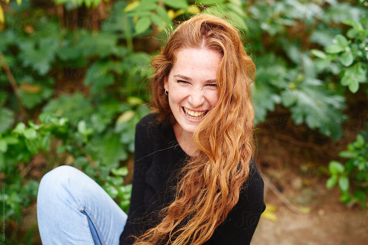 Redhead girl laughing in garden