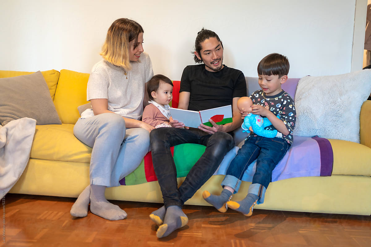 Parents Reading A Storybook To His Children