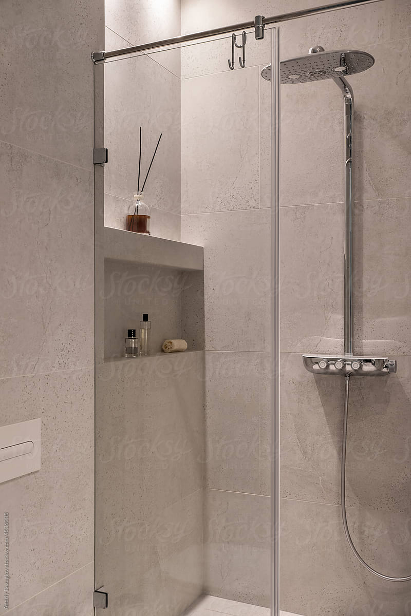Contemporary interior of bathroom with tiled walls