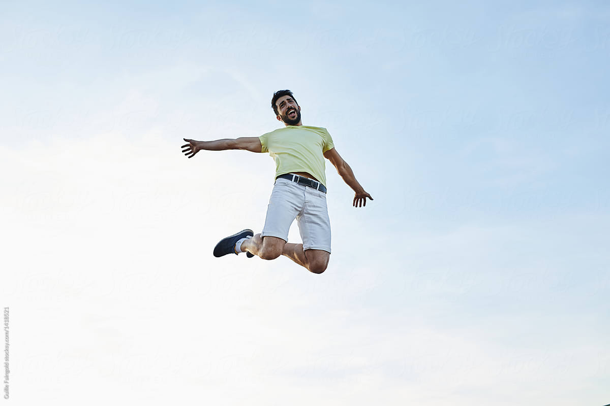 Happy man jumping over sky.