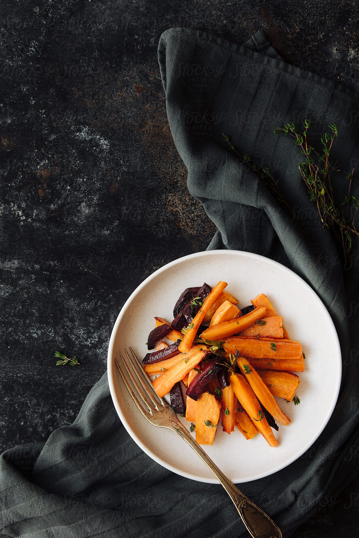 Baked sweet potatoes, beet and carrots with thyme salad