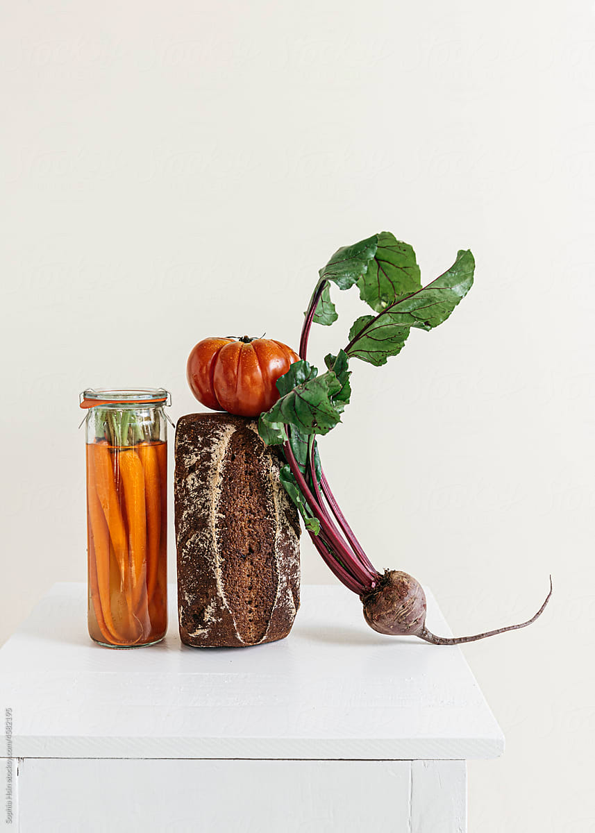 Still life of bread, pickled carrot and vegetables