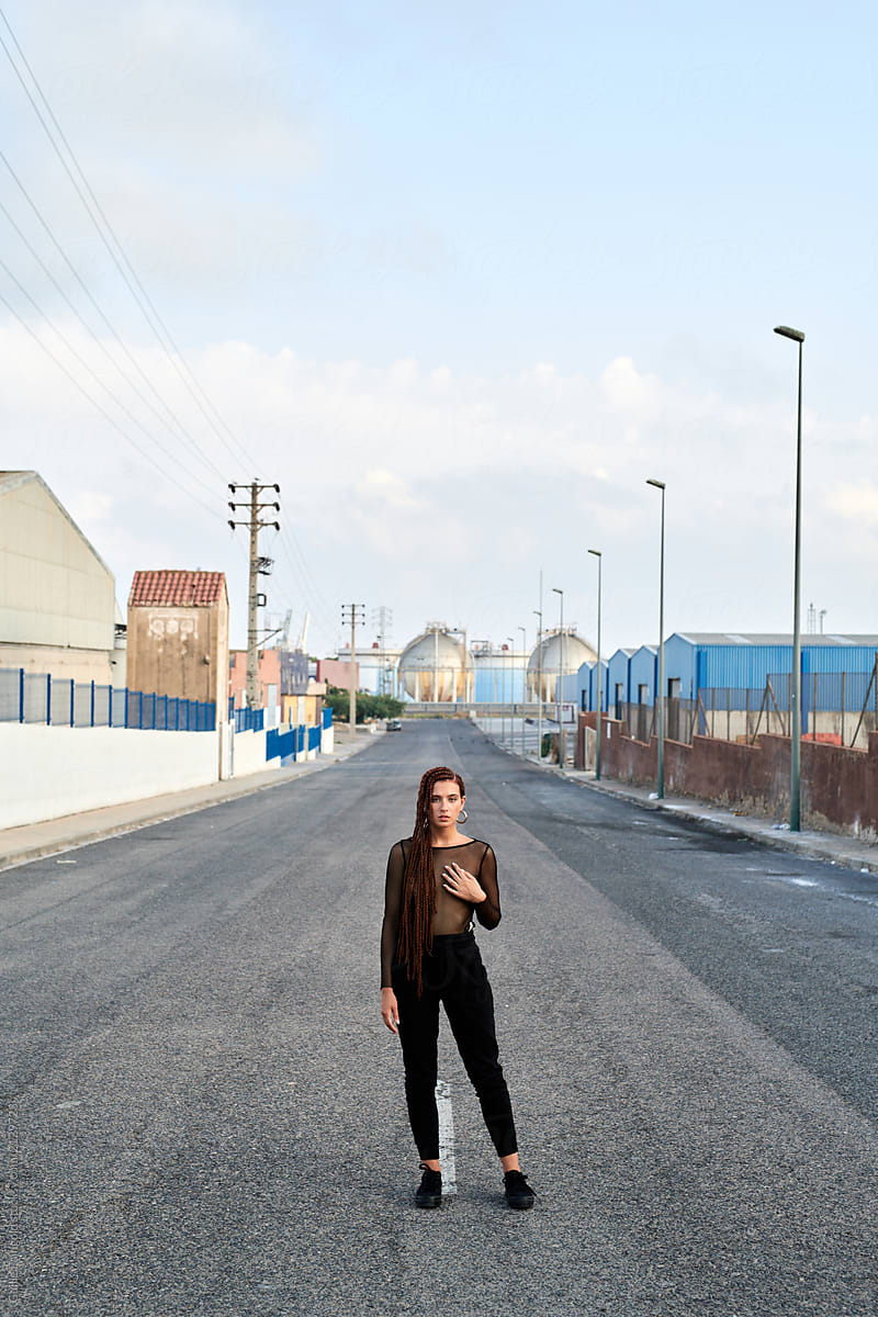 Woman in transparent shirt on empty road.