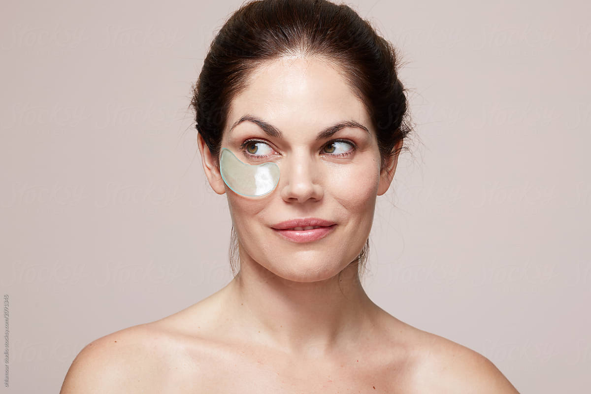 Woman using gel eye patch mask