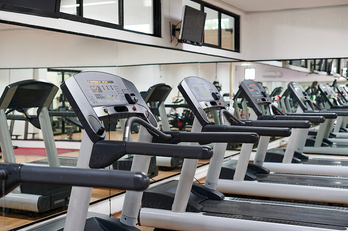 Treadmills sitting in an empty gym