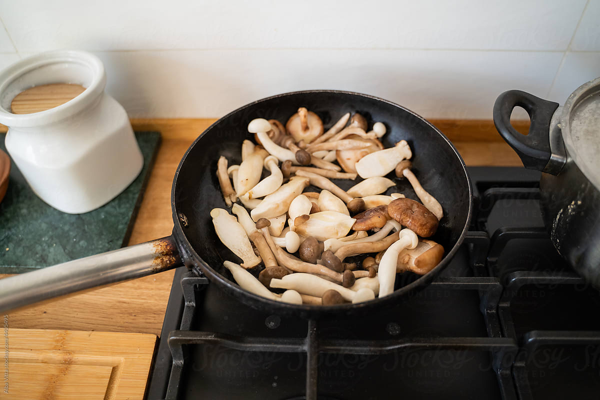 Mushrooms in pan in stove at kitchen