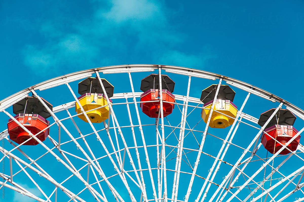 Close- up of bright ferris wheel against of blue sky