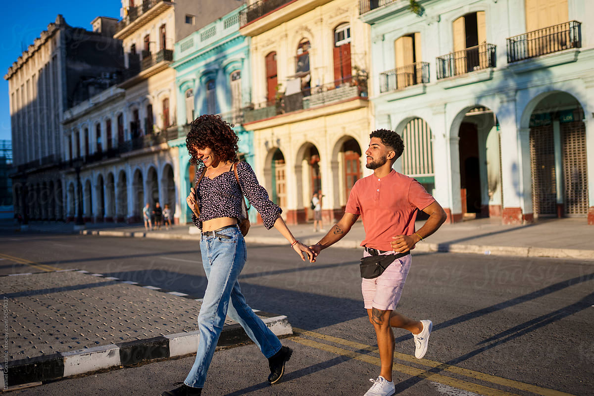Cuban couple crossing street in daytime