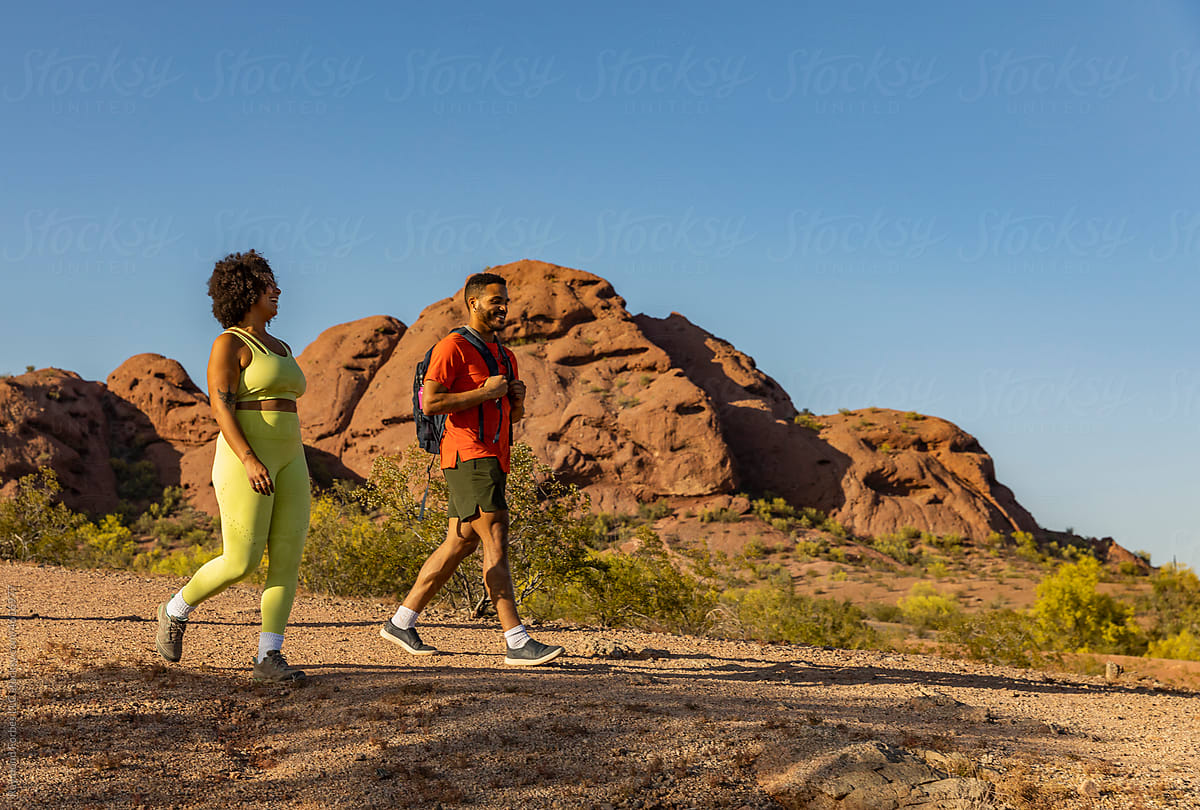 Desert Landscape with two Gen z friends walking on hiking trail