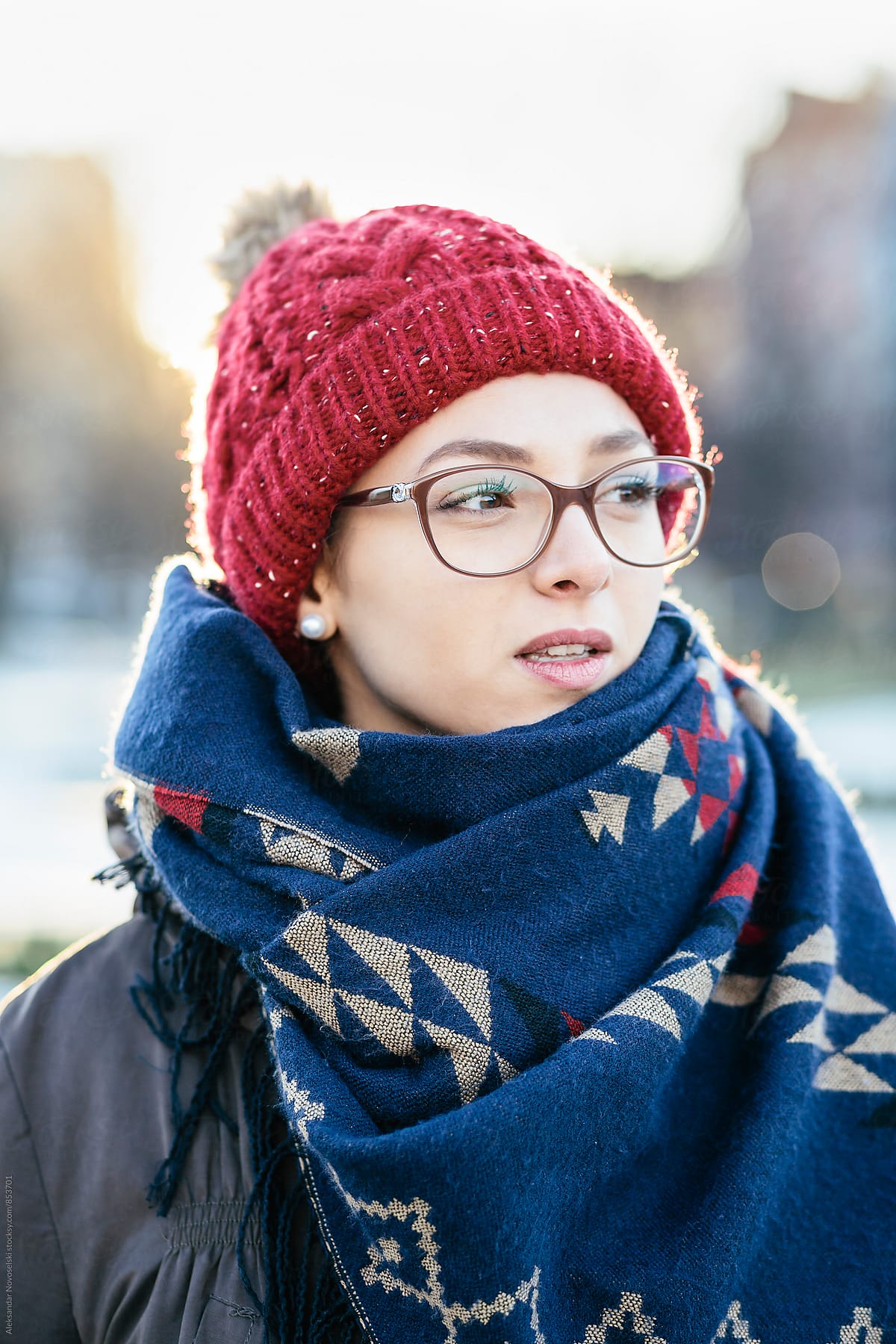  portrait of beautiful young woman with glasses in urban environment
