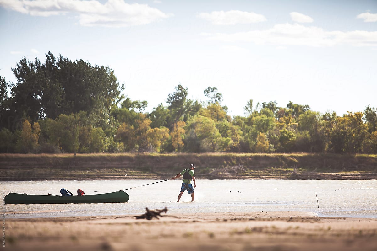 A man with gear and equipment in his canoe on Montana\'s Yellowstone River.