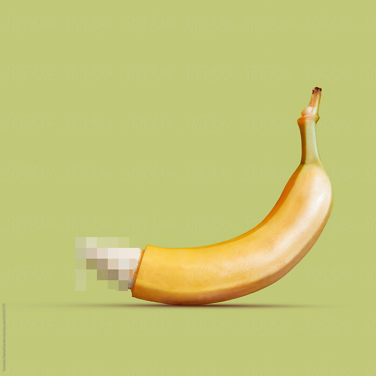 Large banana as a symbol of the penis on a yellow background. by Yaroslav D...