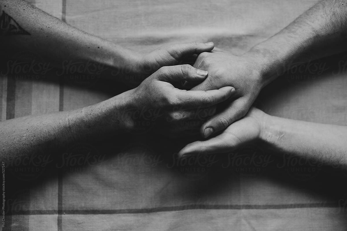 Close up black and white of couple holding hands by Phil Chester  Photography - Stocksy United
