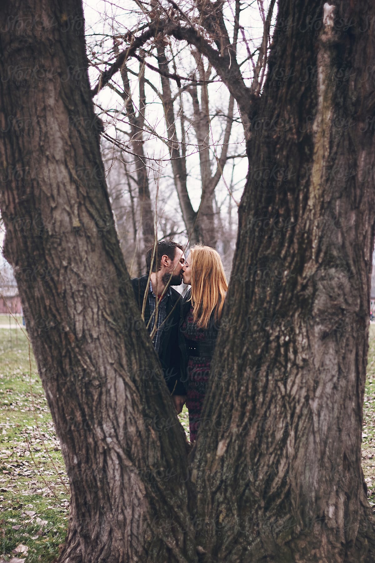 Couple Kissing Each Other Behind The Double Tree Del Colaborador De Stocksy Jovana Rikalo