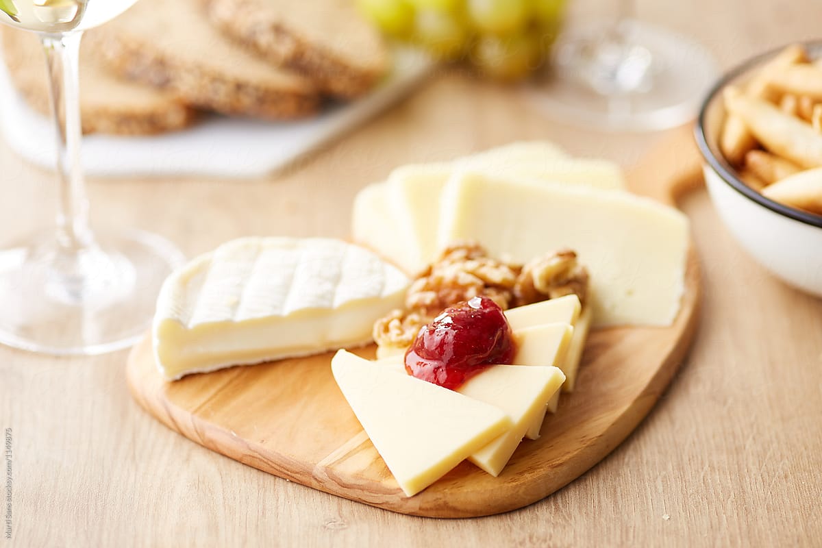 Cheese set with walnuts and jam, breadsticks