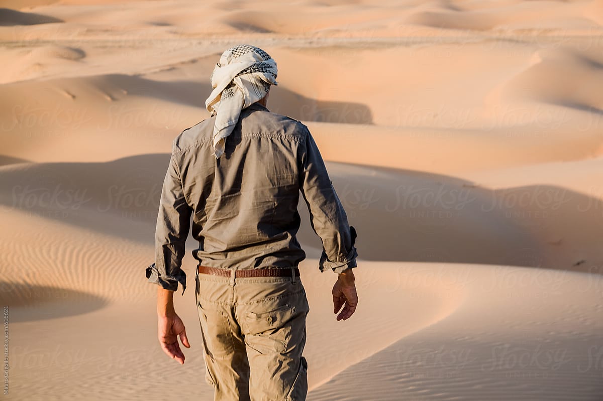 Solitary adventurer walks in the desert