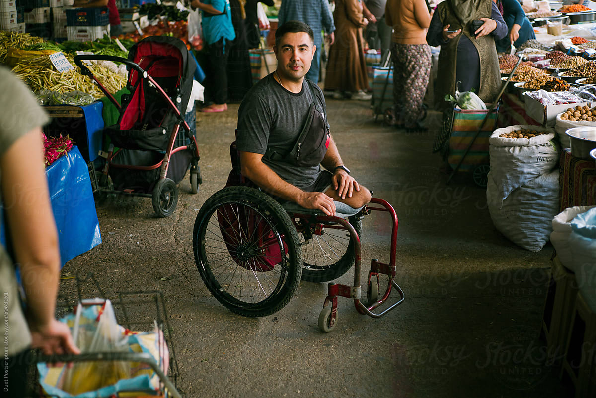 Portrait of a middle-aged disabled man in a street market