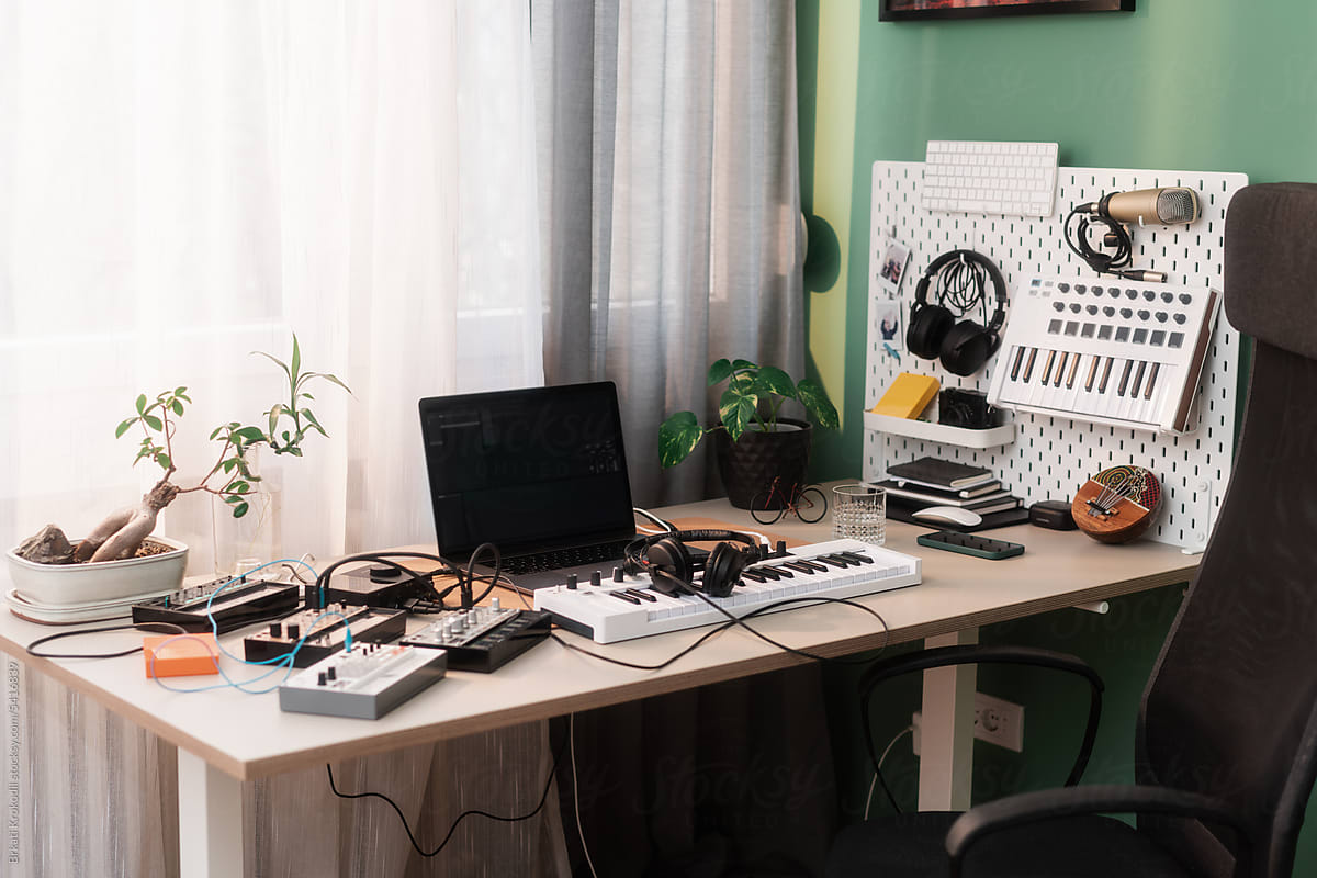 Desk With Music Production Workstation And Instruments
