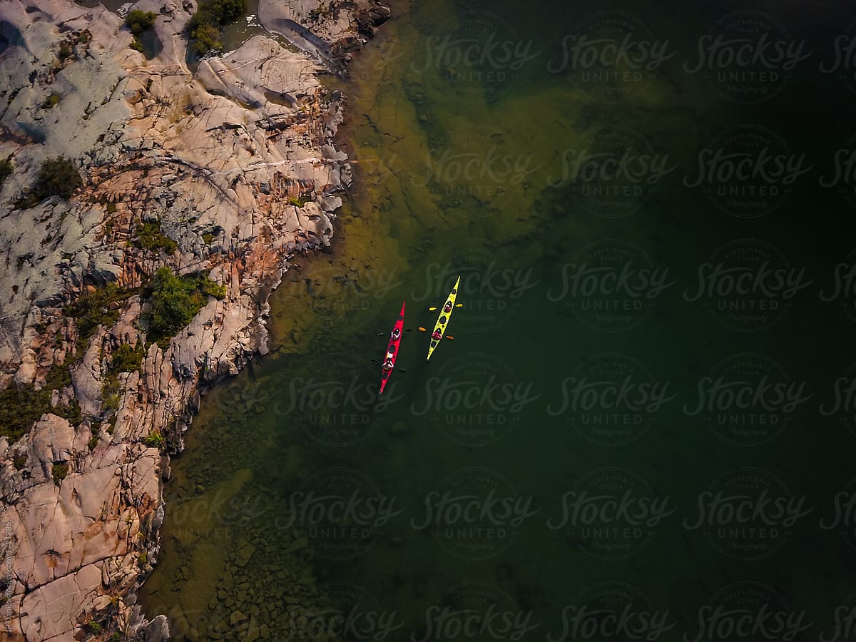 Aerial Photo of Two Sea Kayaks in Water Near Remote Wilderness Island