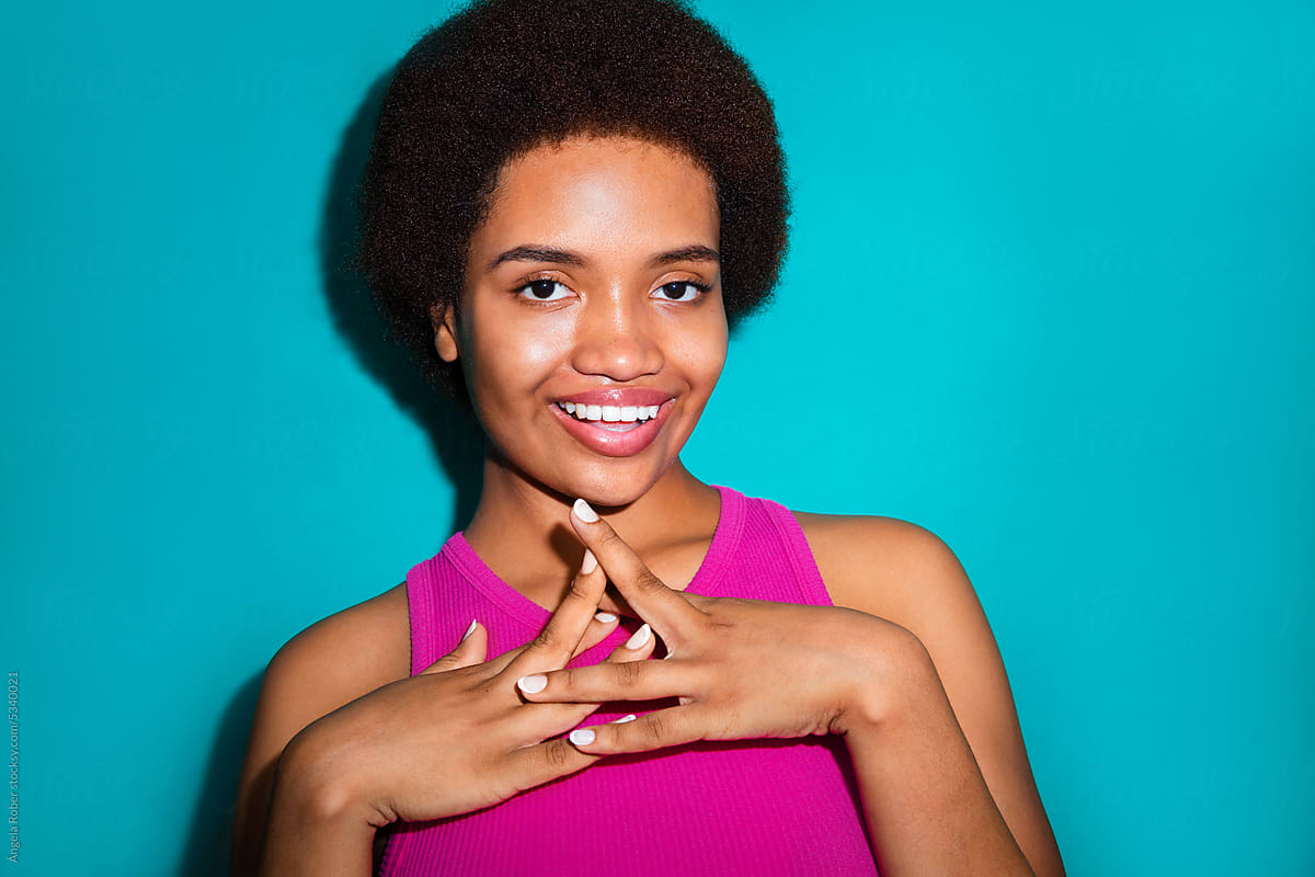 Young smiling woman with her hands on her chest