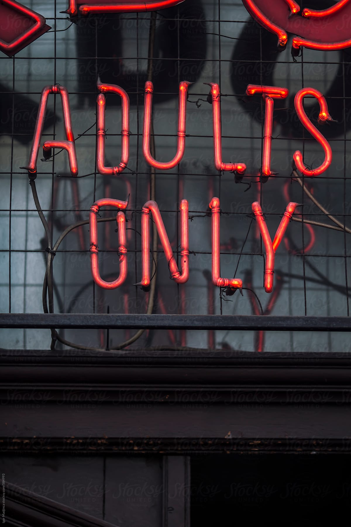 adults only neon sign at the club entrance