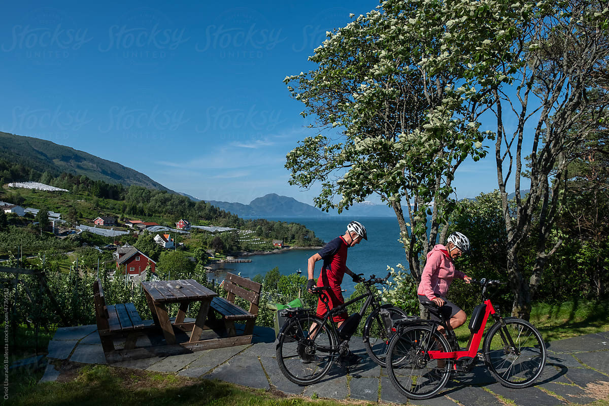 After making a stop, An older couple follow the bicycle route