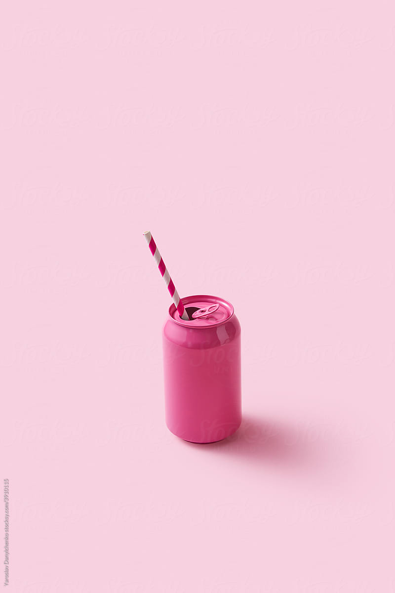Pink soda can with paper straw