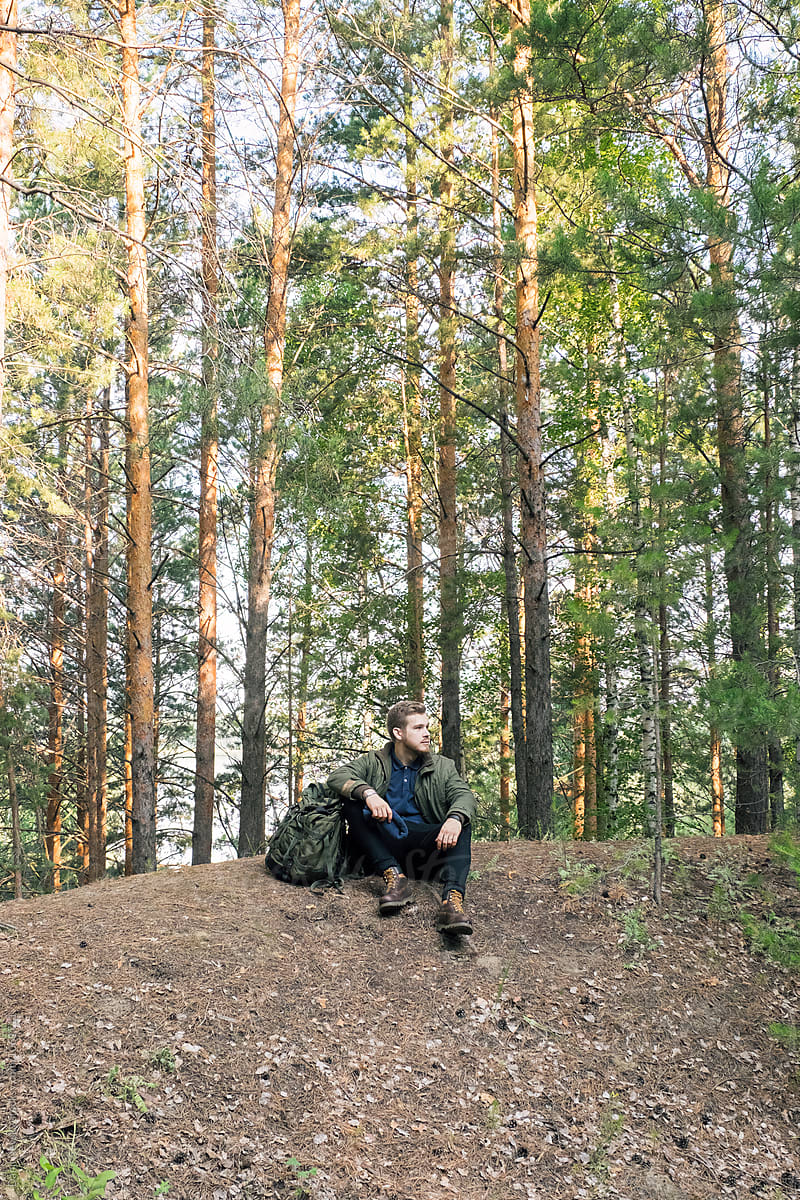 young traveler with backpack in forest