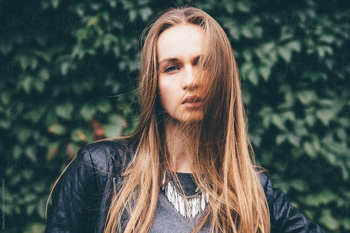 Beautiful Young Woman Looking At Camera On A Background Of Ive By Stocksy Contributor Andrey 