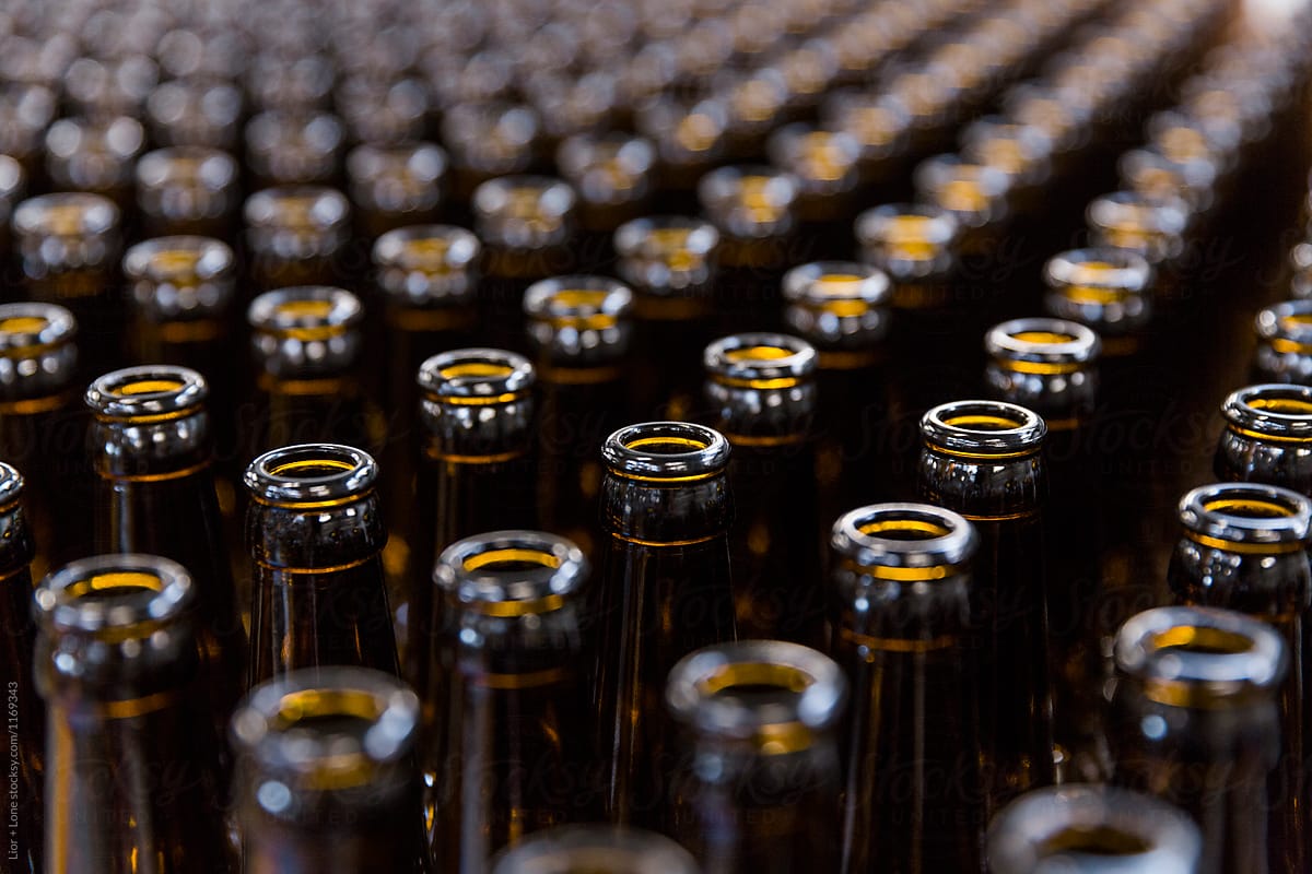 Abstract symmetrical rows of empty beer bottles
