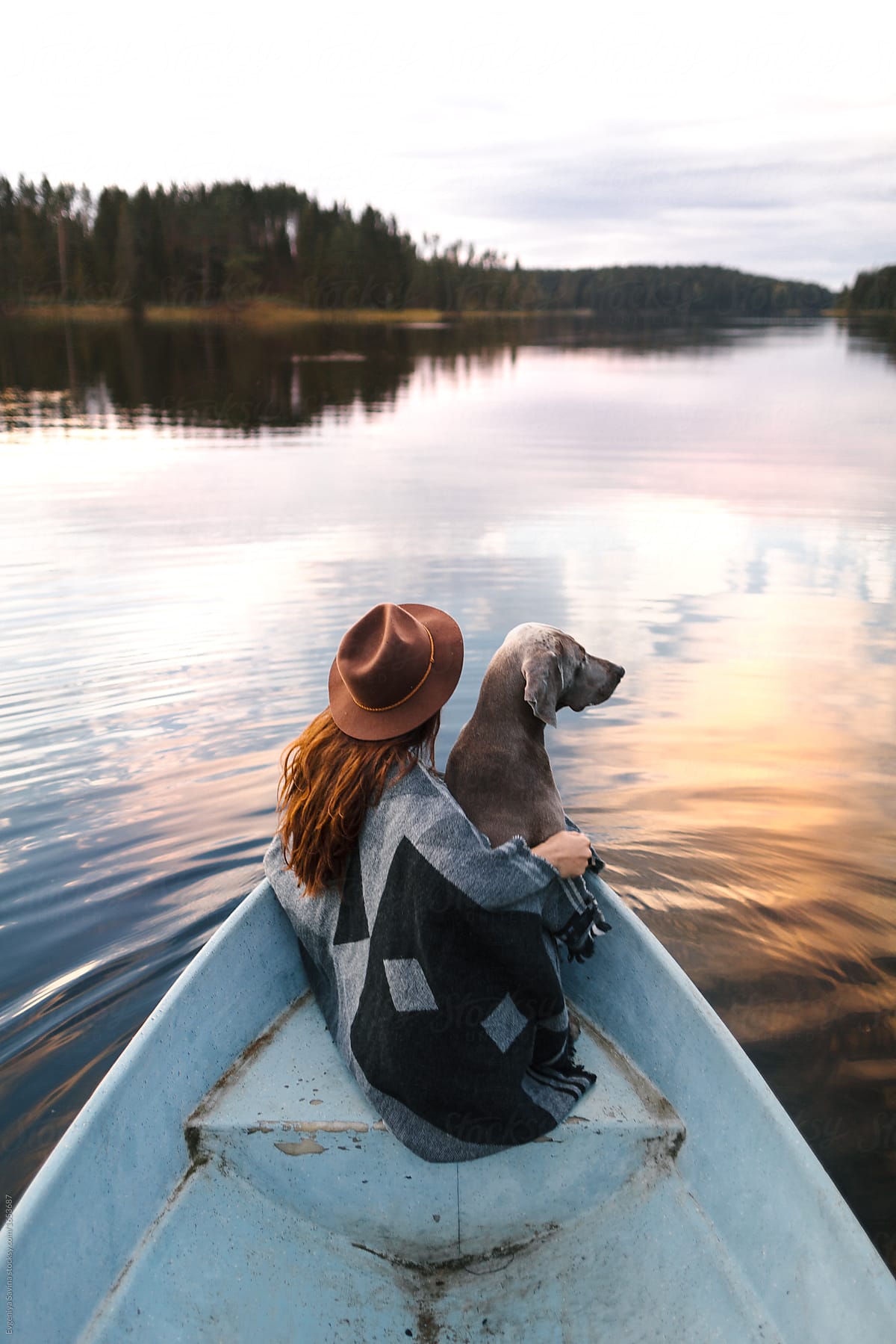 A dog and a girl in the boat