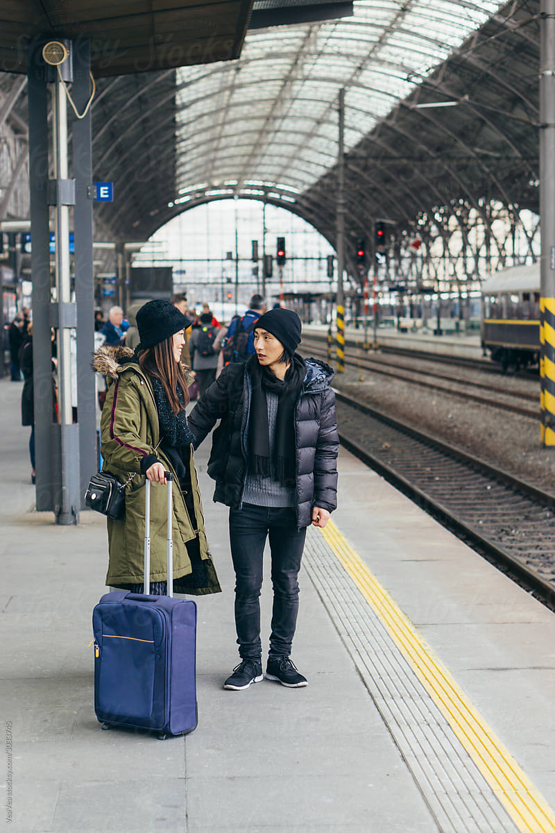 Young Asian couple waiting for a train on a train station