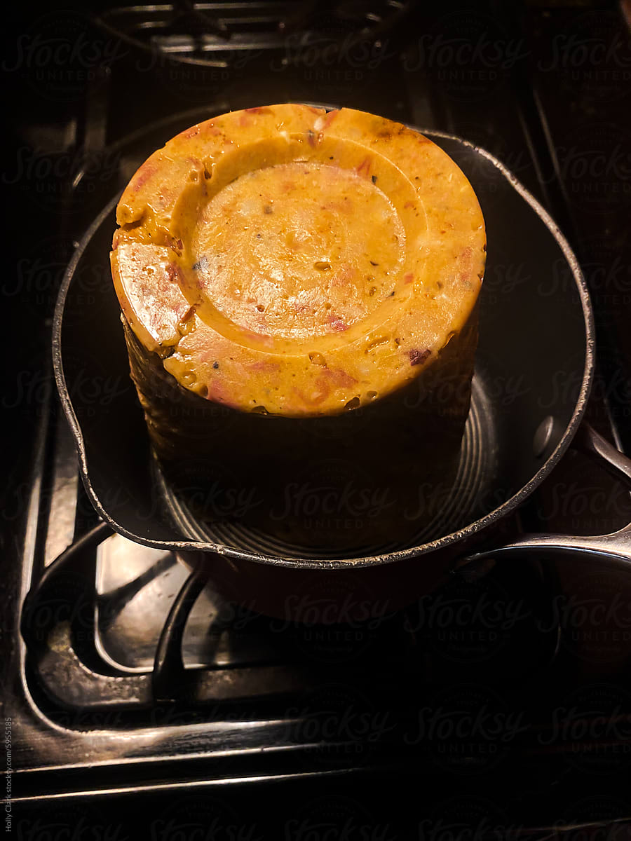 Leftover soup in a pot on a stovetop burner.
