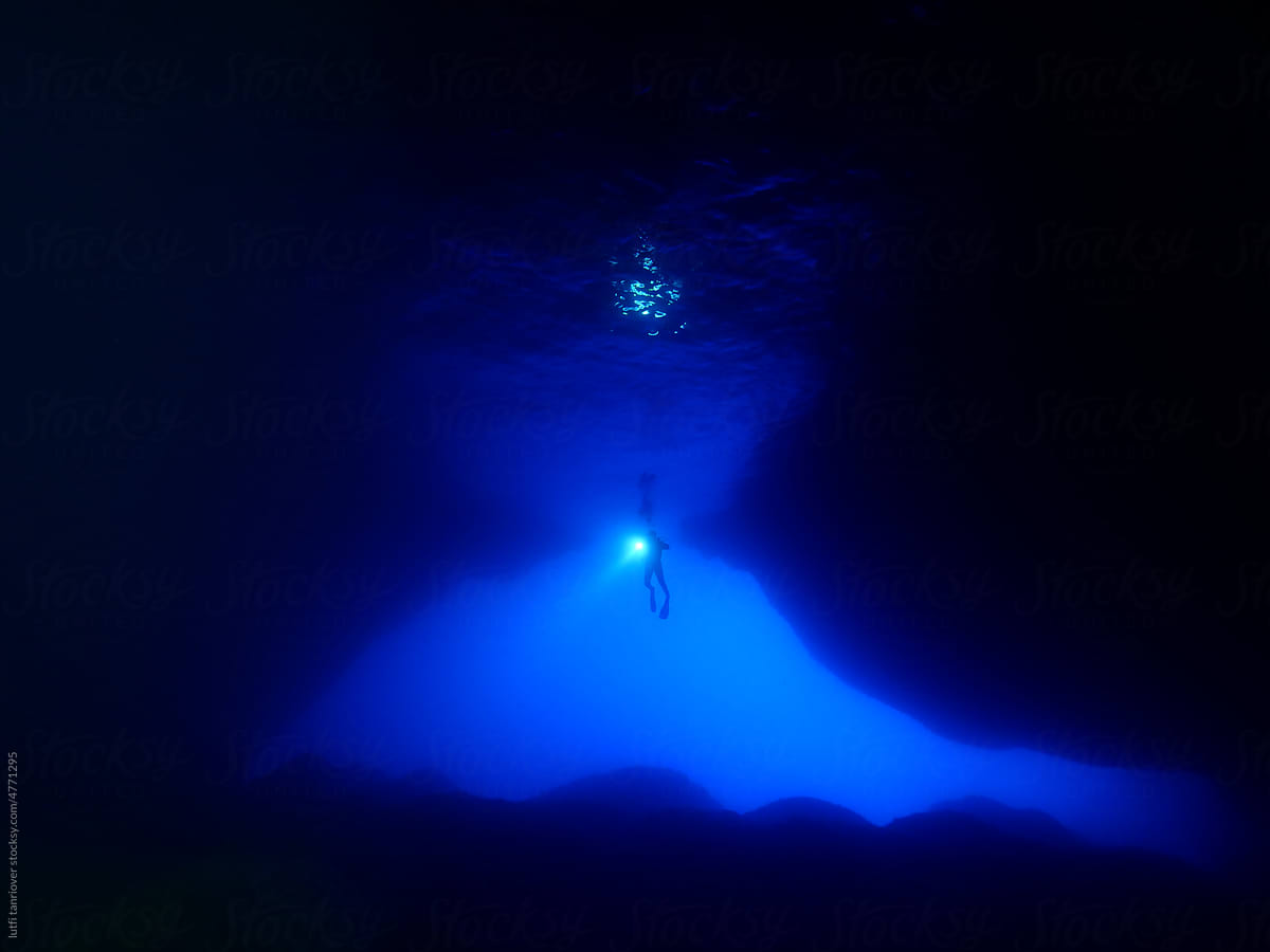 cave diving underwater scuba divers exploring caves and having fun