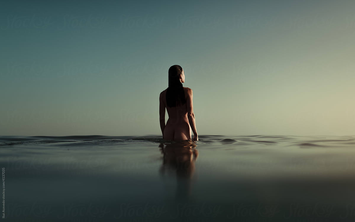 Anonymous woman entering into the sea