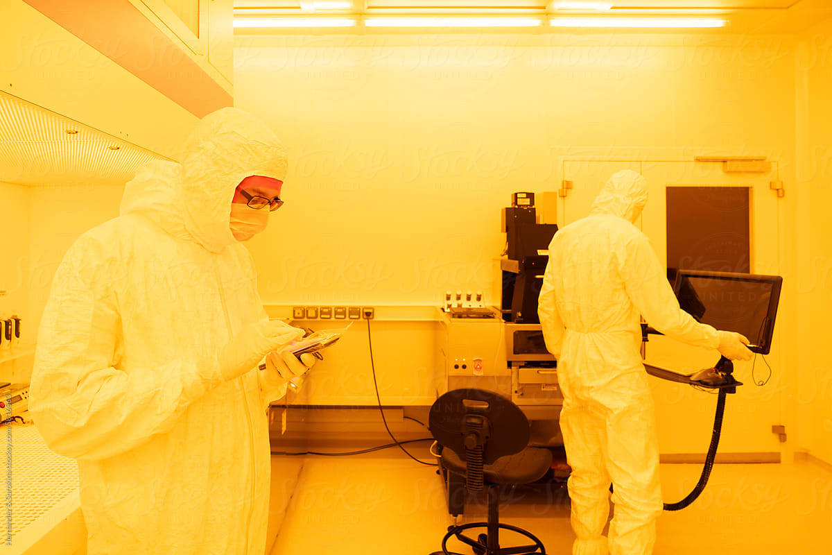 Scientists Working At Clean Room In The Laboratory