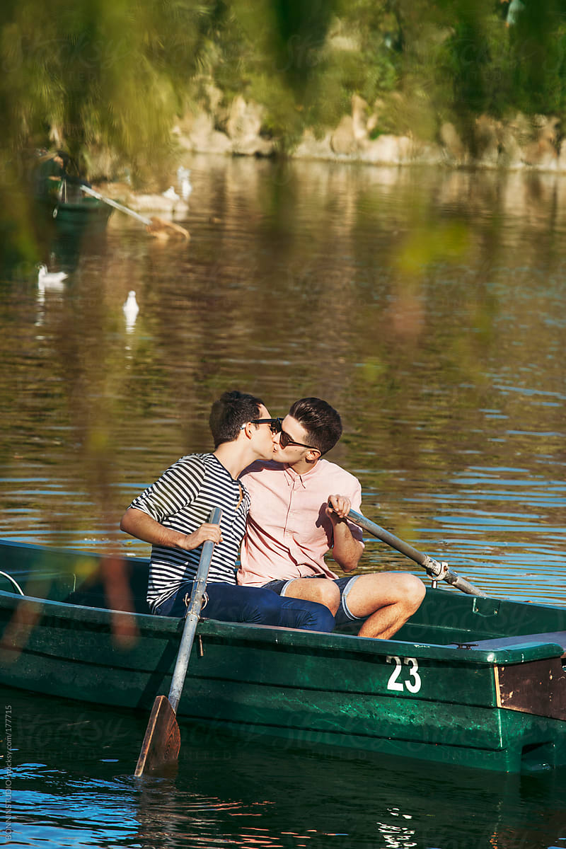 Gay couple kissing on a boat.